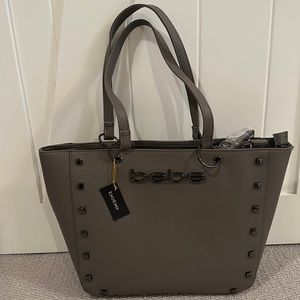 Bebe tote with attached matching makeup bag.